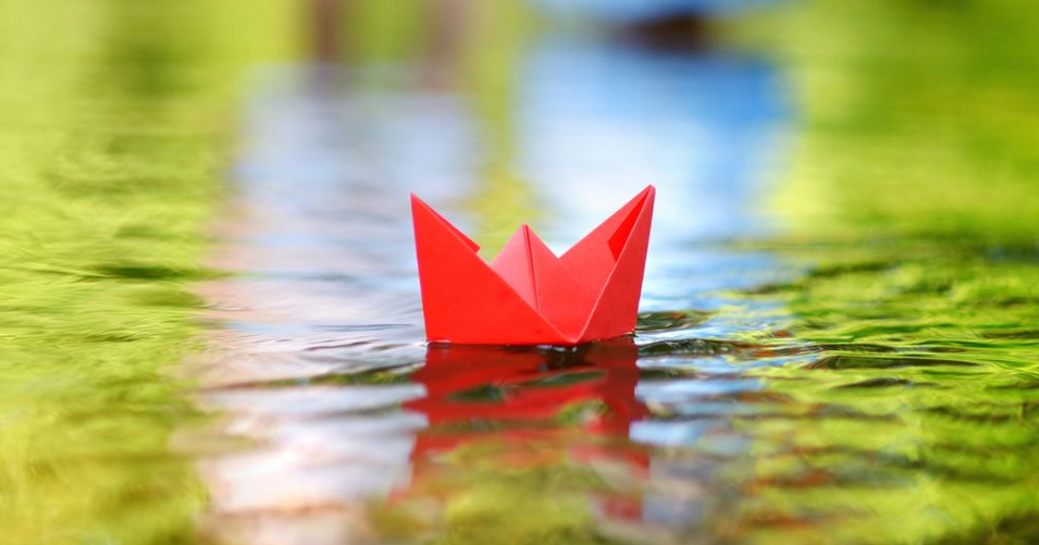 A paper boat floating on a river